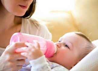 Baby trinkt aus dem Fläschchen